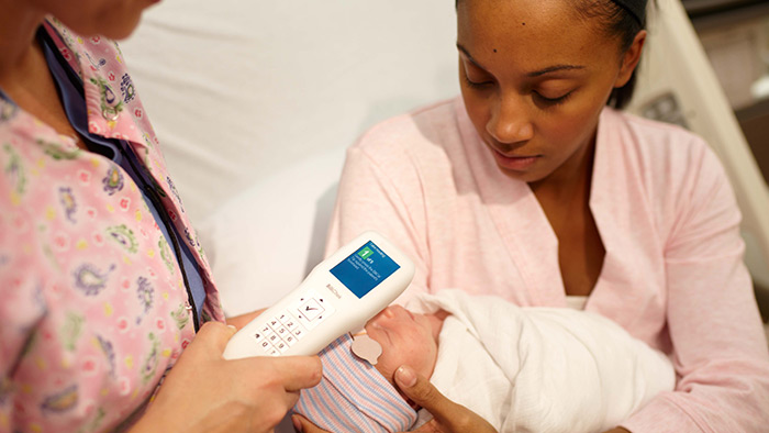 uma mulher a segurar um beb&eacute;